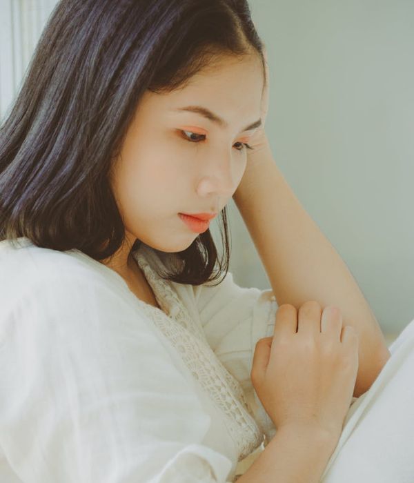 Person stretching gently indoors with soft natural light.